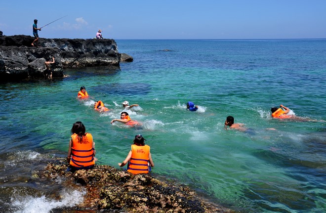 
Kh&aacute;ch du lịch trong nước, quốc tế vui chơi, tắm biển ở đảo B&eacute; (huyện đảo L&yacute; Sơn). Ảnh: M.Ho&agrave;ng.
