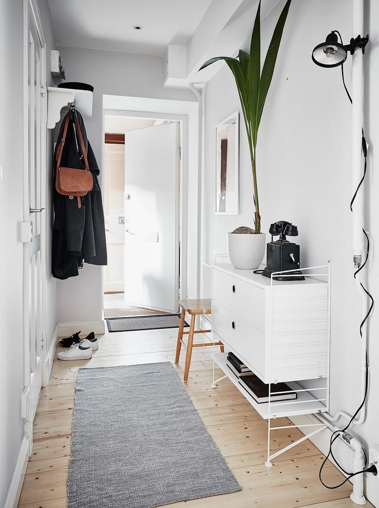 Lối vào nhà được bài trí đơn giản với móc treo và tủ để đồ.