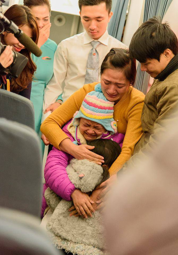 Giây phút cả gia đình Linh xúc động khi bất ngờ được đoàn tụ trên máy bay. Ảnh: BEATVN.