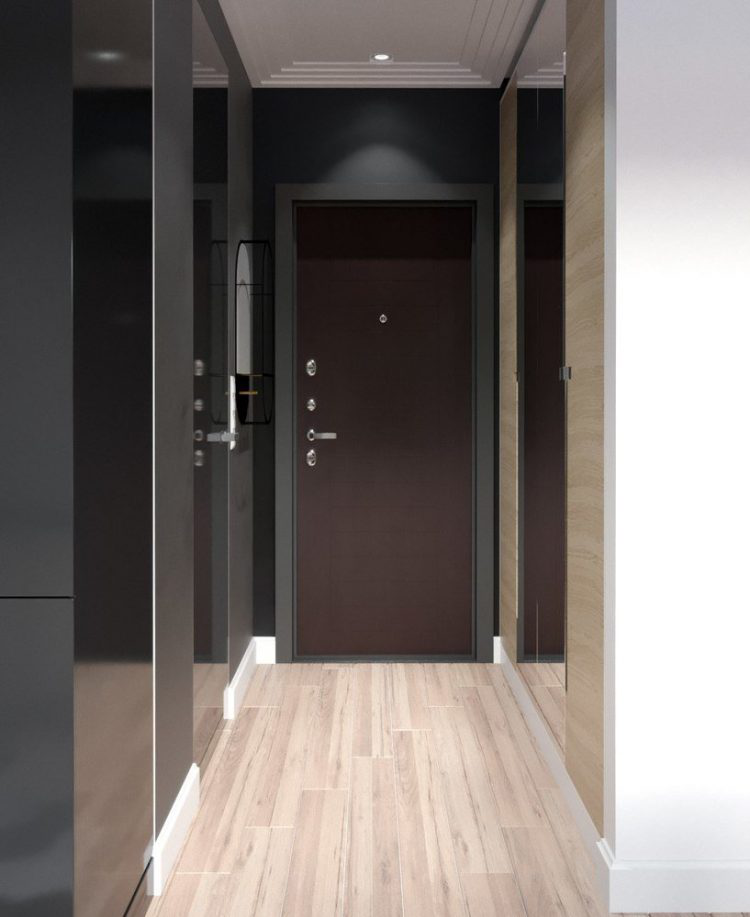 Lối vào nhà được thiết kế đơn giản với sự kết hợp hài hòa giữa tông màu sáng của sàn gỗ và màu tối của tường nhà, cửa ra vào.