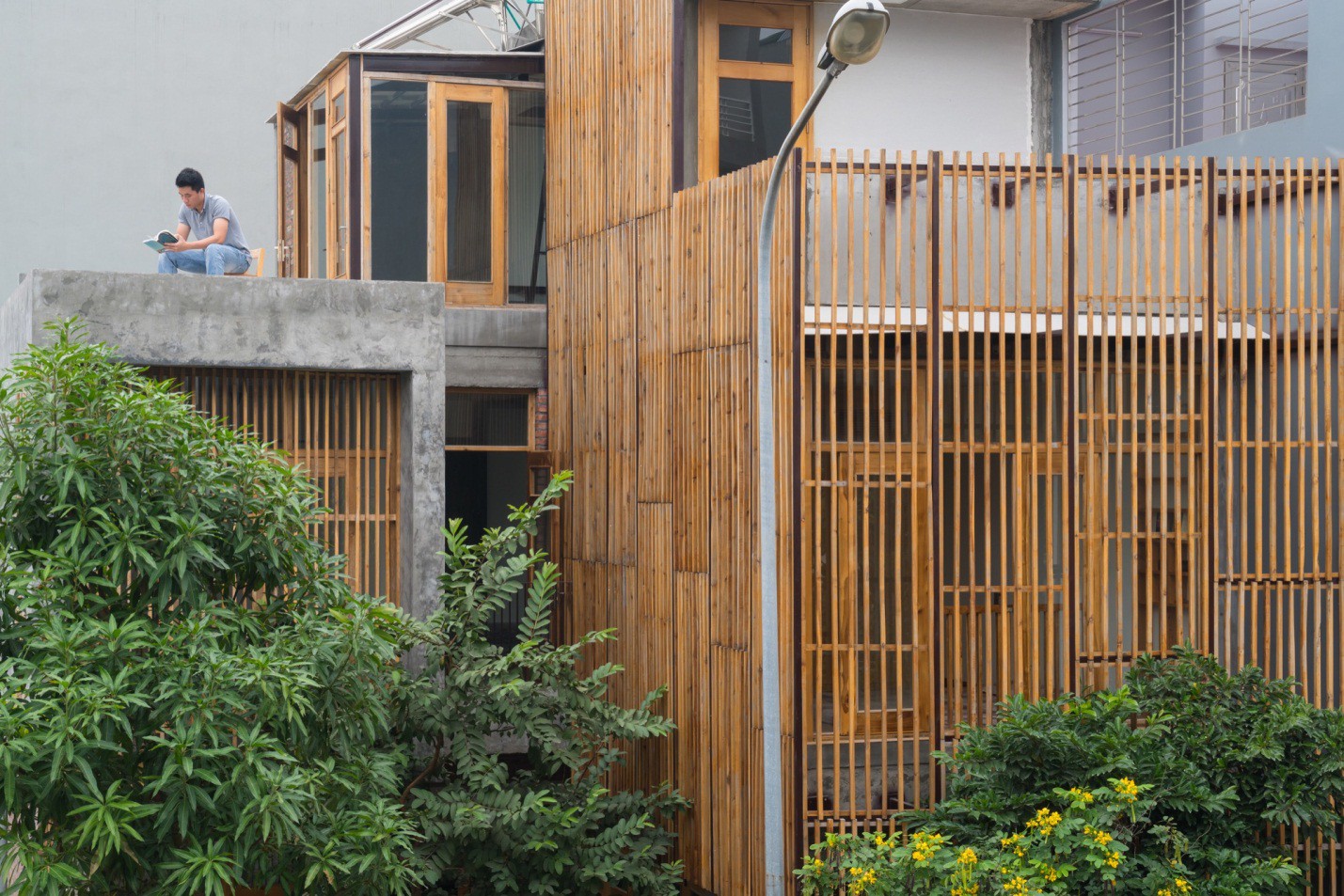 Điểm lôi cuốn đặc biệt của công trình này đó là hai mặt tiền được thiết kế vô cùng độc đáo với gạch mộc và hệ lam gỗ chạy dọc không gian.