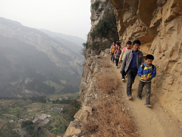 
Trẻ em men theo vách đá dựng đứng đề tới lớp ở tỉnh Quý Châu, Trung Quốc.
