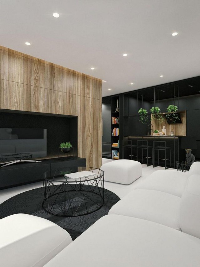 Không chỉ gây ấn tượng đặc biệt bởi 2 tông màu đối lập đen-trắng, sự xuất hiện của cây xanh và hệ tủ gỗ nơi phòng khách càng làm cho không gian trở nên nổi bật hơn. 