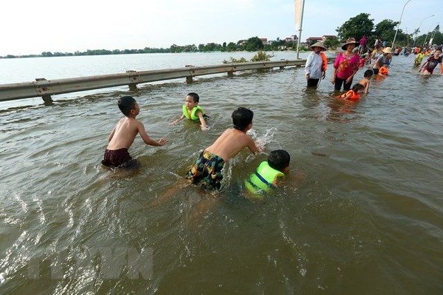 Tỉnh lộ ngập sâu, dân thôn ở Hà Nội nô nức đi bắt cá, cho trẻ ra bơi  - Ảnh 5.