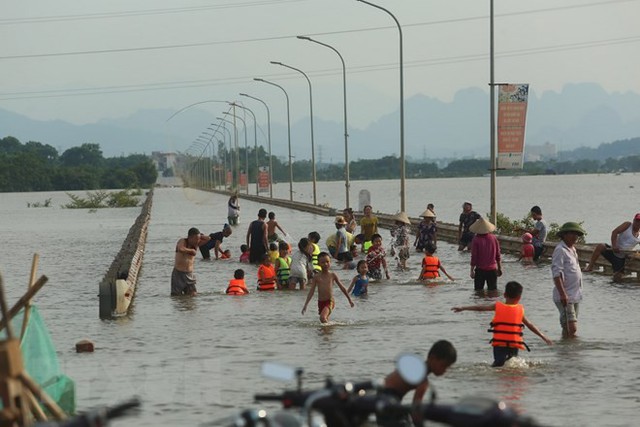 Tỉnh lộ ngập sâu, dân thôn ở Hà Nội nô nức đi bắt cá, cho trẻ ra bơi  - Ảnh 6.