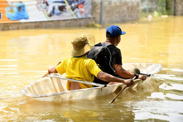 Sau 1 tuần mưa, người Hà Nội dùng thuyền tự chế, bơi trong dòng nước ngập ao bèo về nhà - Ảnh 7.