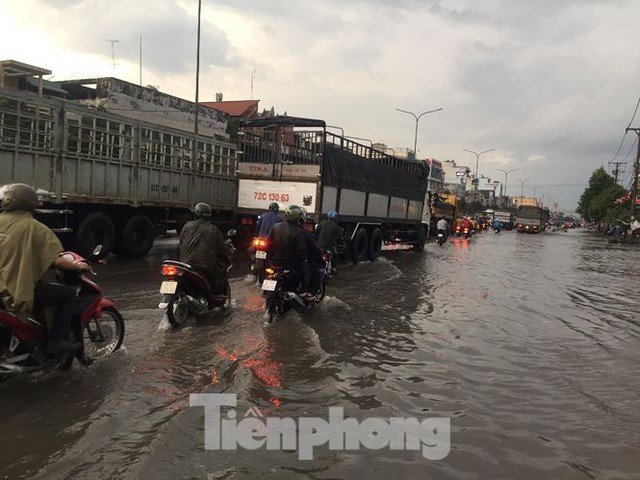 Nước chảy như thác đổ sau mưa, nhiều tuyến đường ở Sài Gòn ngập nặng - Ảnh 2.