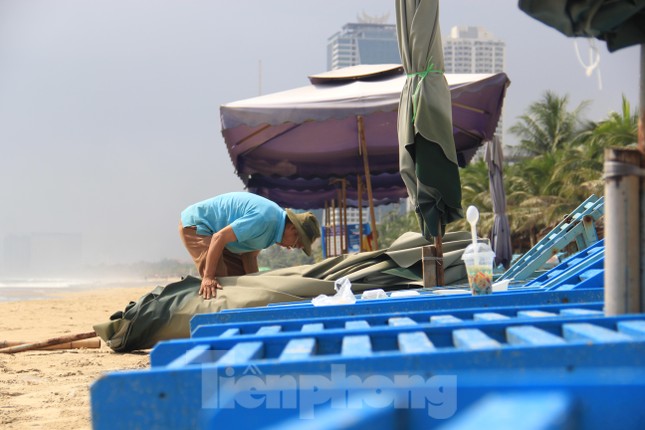 Người dân Đà Nẵng thu dọn hàng quán, hối hả xếp dù trên bãi biển chạy bão - Ảnh 3.
