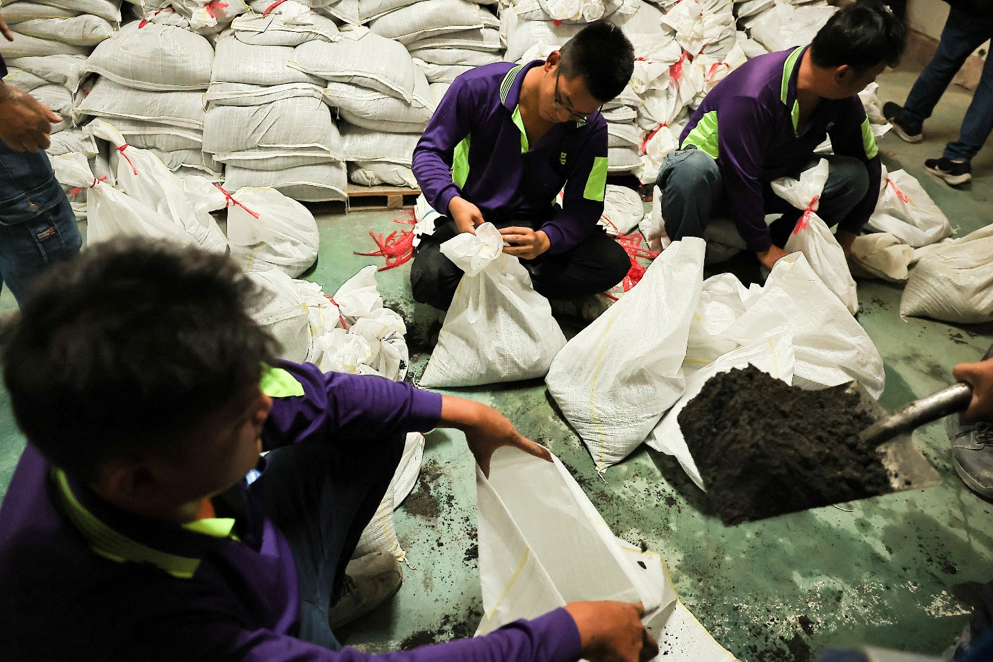 Staff prepare sandbags for Typhoon Krathon in Kaohsiung