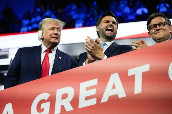 Former President Donald Trump appears with Republican vice president nominee JD Vance and Speaker of the House Mike Johnson during the first day of the Republican National Convention on July 15, 2024, in Milwaukee, Wisconsin.