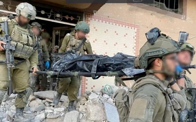 IDF soldiers carry the body of Hamas leader Yahya Sinwar from the building where he was killed in Rafah, Gaza on October 17, 2024. (Courtesy) https://www.timesofisrael.com/liveblog_entry/idf-soldiers-seen-carrying-body-of-man-believed-to-be-sinwar-on-stretcher-en-route-to-israel-from-gaza/