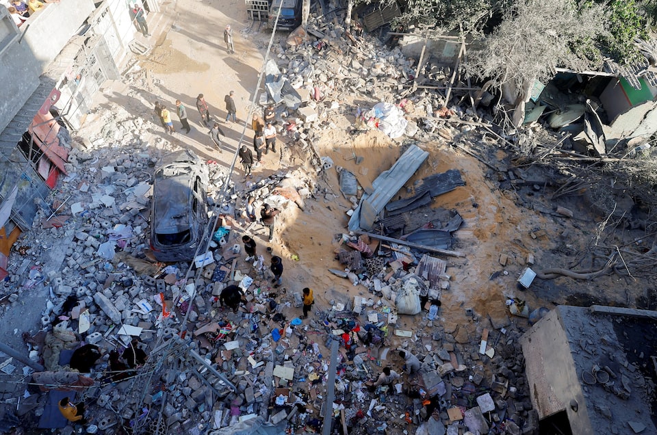 Người dân Palestine kiểm tra khu vực xảy ra cuộc tấn công của Israel ở Rafah, Gaza hôm 8-5. Ảnh: Reuters