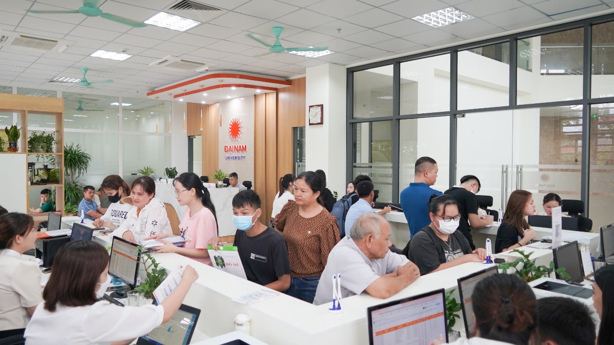 A group of people in a room with computers  Description automatically generated