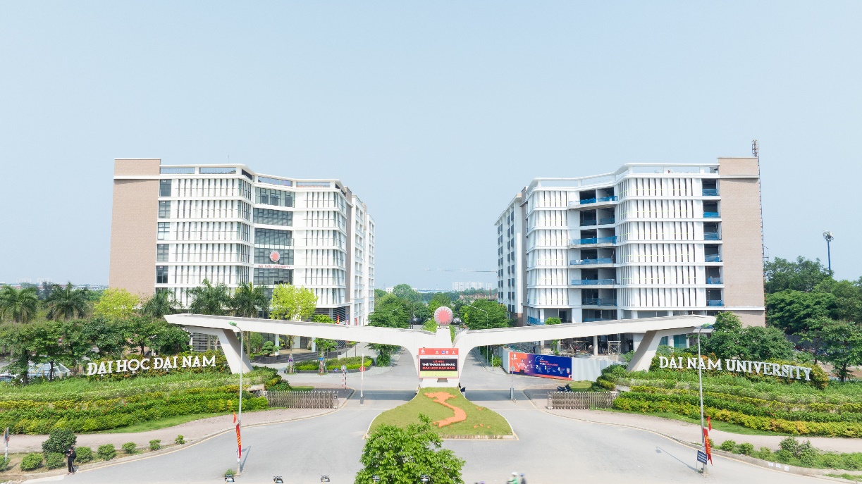 A bridge over a road with buildings in the background  Description automatically generated