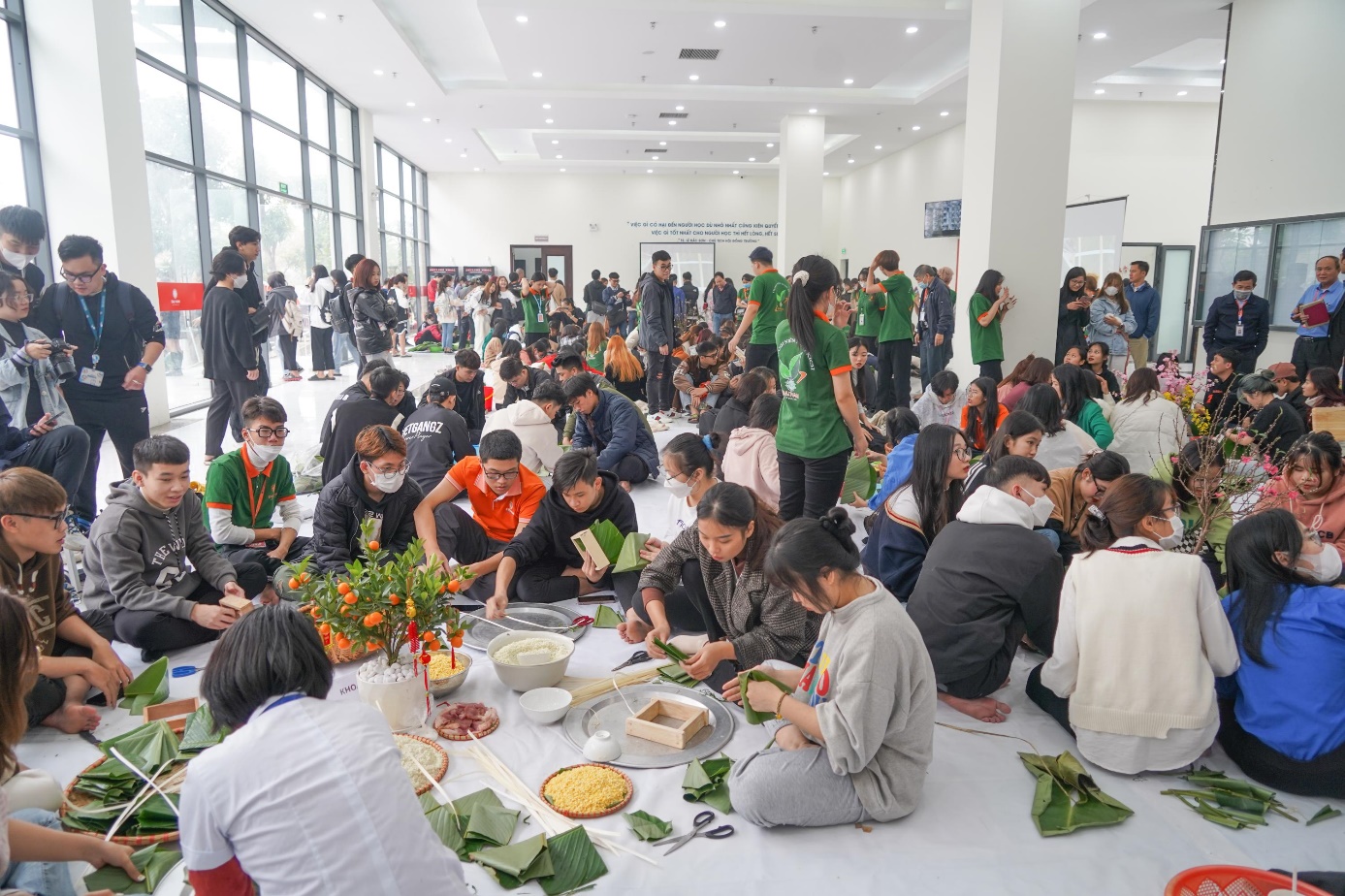 A group of people sitting on the floor  Description automatically generated