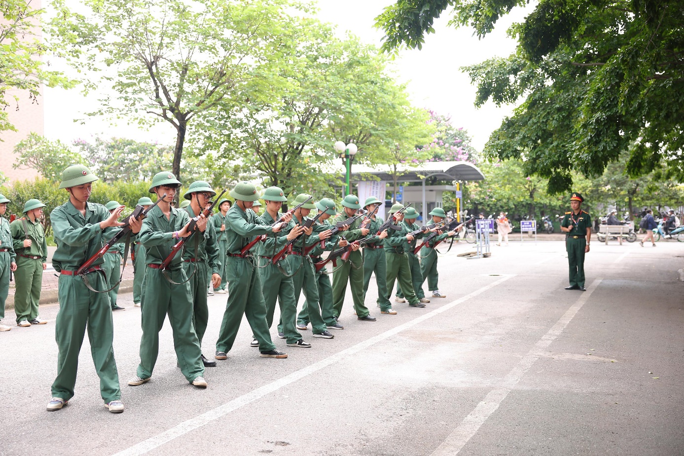 A group of soldiers marching in a line  Description automatically generated