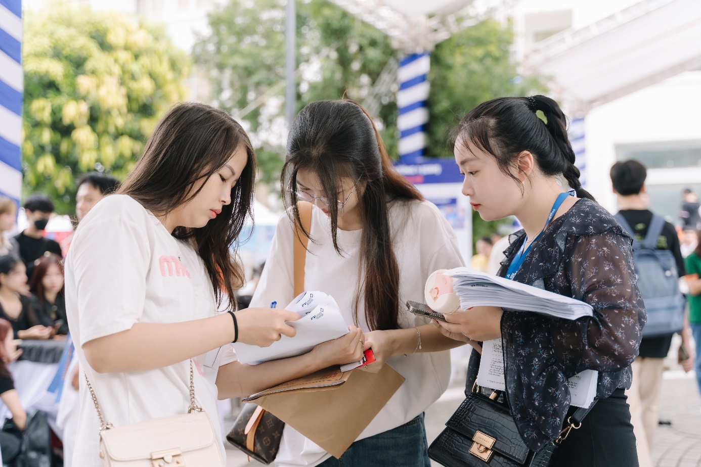 A group of women looking at papers  Description automatically generated