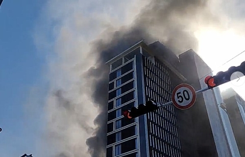 Smoke billows from a construction site in Busan on Feb. 14, 2025, in this photo provided by a reader. (PHOTO NOT FOR SALE) (Yonhap) 