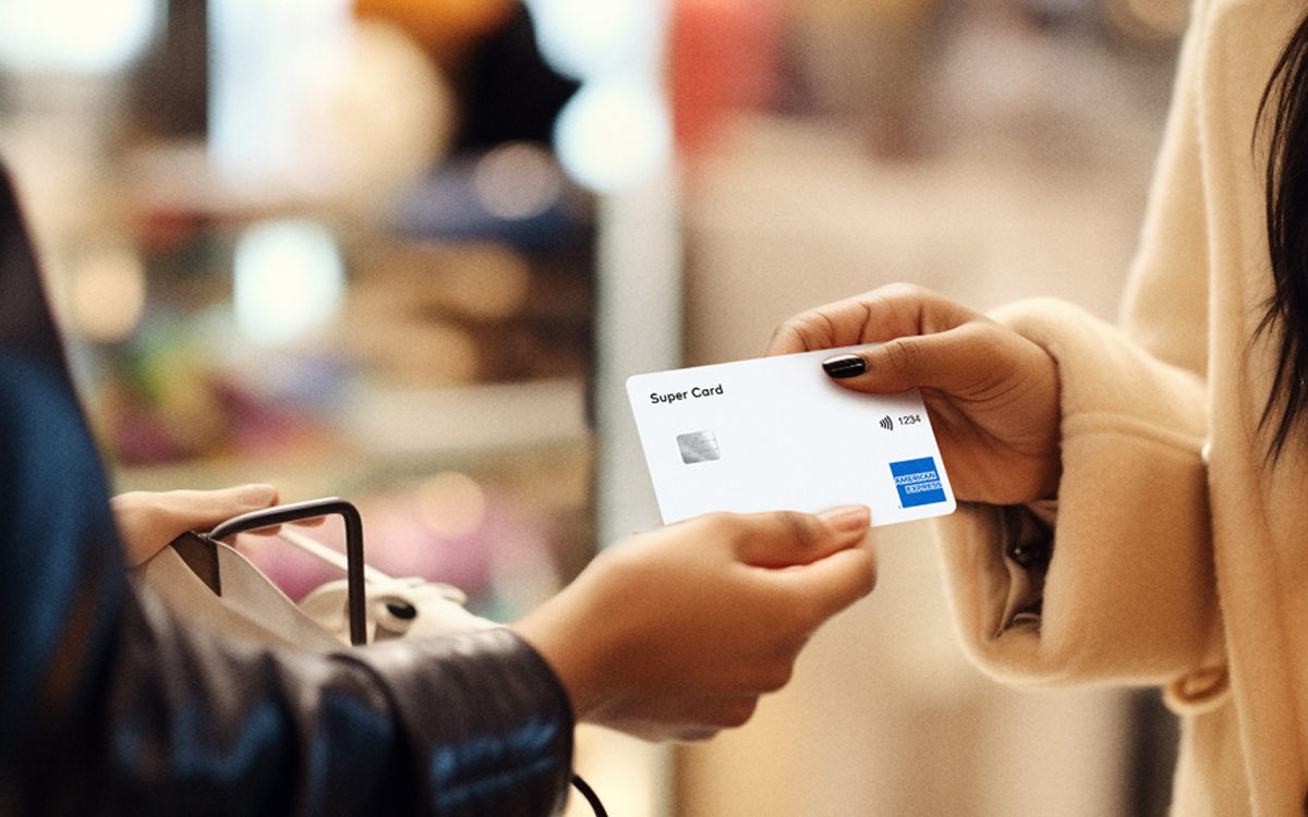 A close-up of a person handing a credit card to another person  AI-generated content may be incorrect.