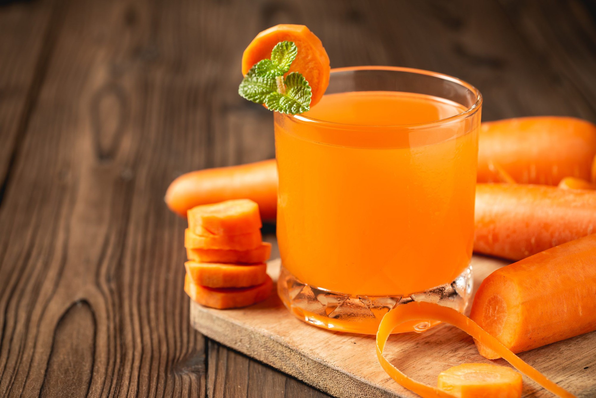 carrot-juice-glass-wooden-table-scaled.jpg