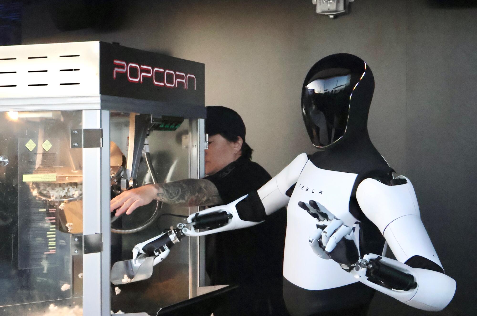 Tesla ra mắt trạm sạc với phong cách độc lạ, mỗi tội robot Optimus xúc bỏng ngô mà vãi như trẻ con học dùng thìa- Ảnh 1.