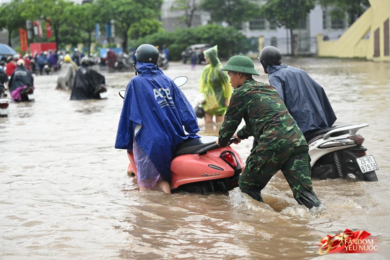 Ảnh đẹp sáng nay: Các chiến sĩ làm nhiệm vụ A80 lội nước đẩy xe, dìu dân qua đoạn ngập sâu ở Hà Nội- Ảnh 10.