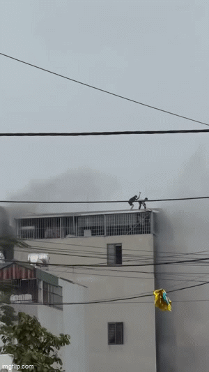 2 người phá mái tôn cứu các nạn nhân từ căn nhà 6 tầng cháy dữ dội ở Hà Nội - Ảnh 1.