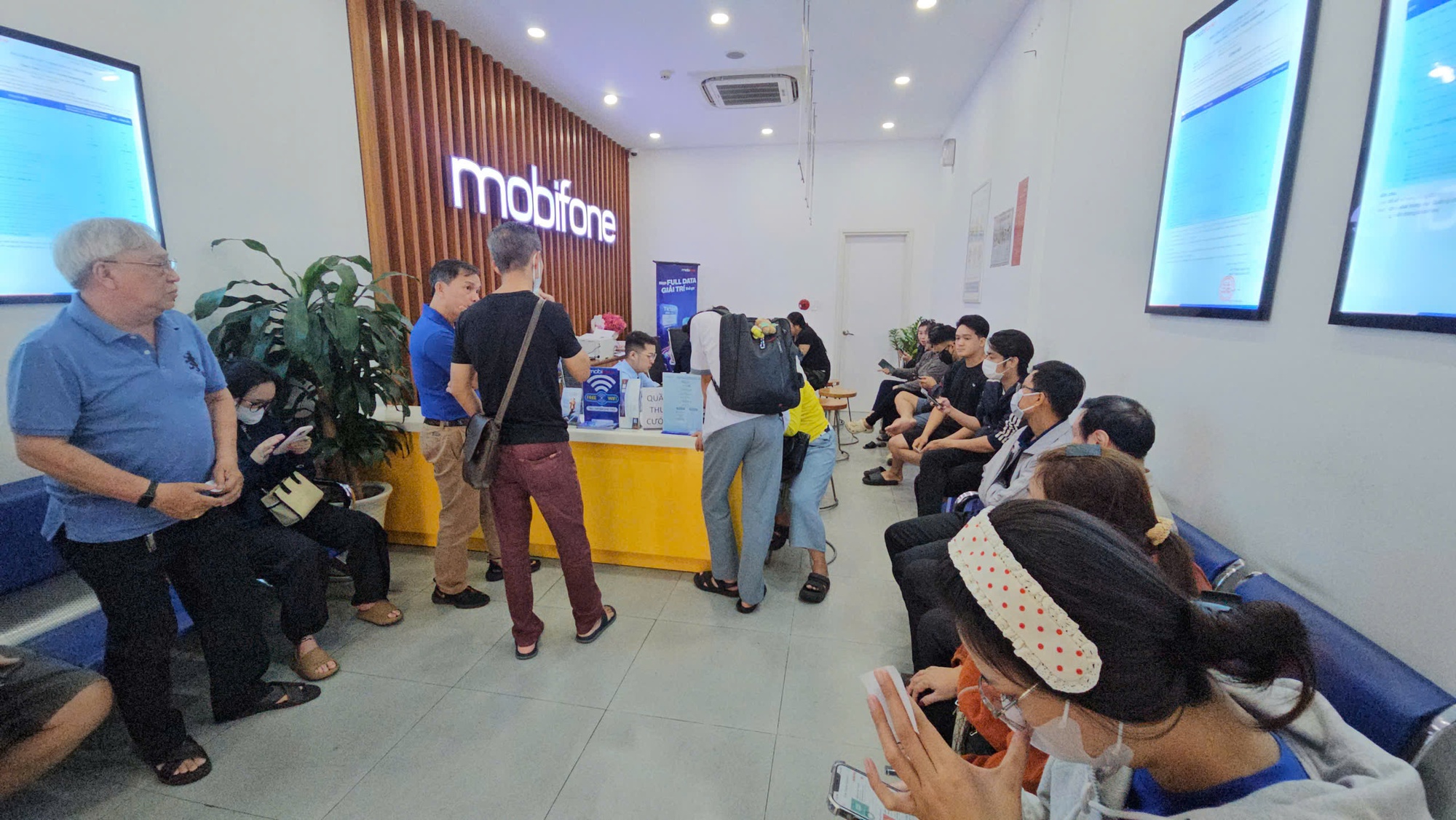 Lo bị khóa SIM điện thoại, người dân ùn ùn đi làm thủ tục xác thực thuê bao chính chủ - Ảnh 1.