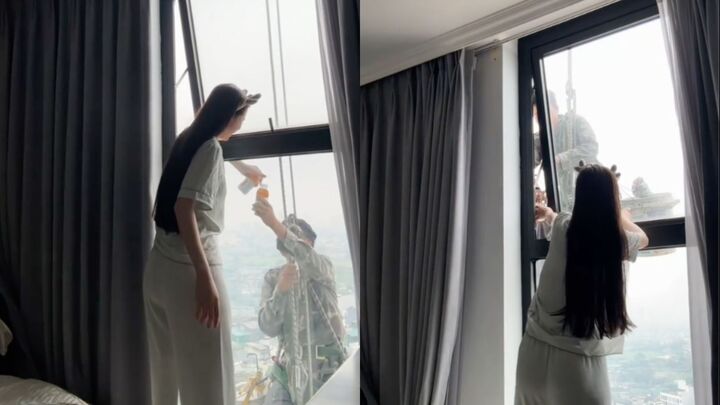 Mát lòng cảnh cô gái mời nước anh thợ treo mình giữa trời nóng lau kính cao ốc- Ảnh 1.