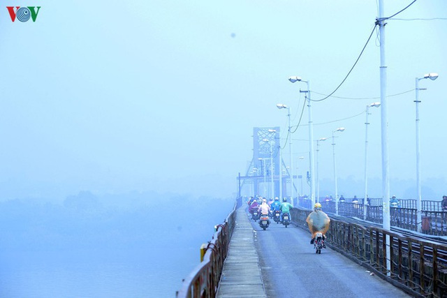  Phố phường Hà Nội chìm trong mịt mù sương, bụi dù vào giữa trưa - Ảnh 7.