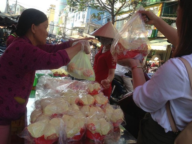 Người dân Sài Gòn xếp hàng mua chè, heo quay cúng Thần tài - Ảnh 2.