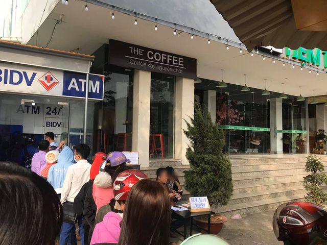 Góc cơ hội: Người đàn ông kê bàn mở dịch vụ rút tiền nhanh ngay cạnh cây ATM đang có hàng chục người chen chúc ngày giáp Tết - Ảnh 1.
