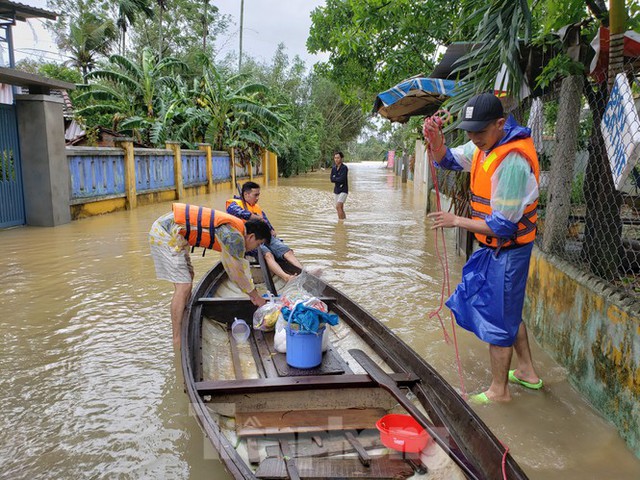 Ngập sâu cả mét, nhiều người Đà Nẵng lội nước, chèo thuyền cả km để đi chợ - Ảnh 10.