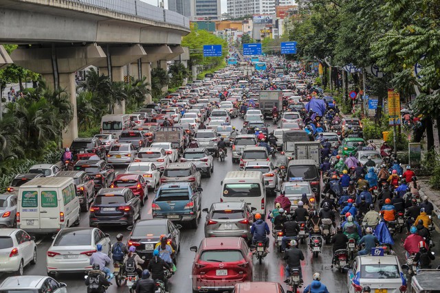 Đường phố Hà Nội ùn tắc nhiều giờ sau cơn mưa lớn - Ảnh 1.