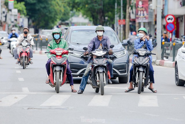 Hà Nội thương ngày nắng về, người dân che ô, đội áo, bịt kín mít ra đường - Ảnh 2.