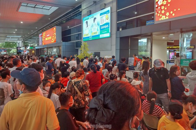 Sân bay Tân Sơn Nhất đông nghịt người đón Việt kiều - Ảnh 1.