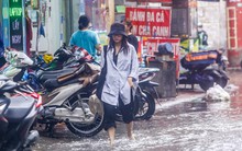 Người dân bì bõm về nhà trên những con phố ngập nước ở Hà Nội